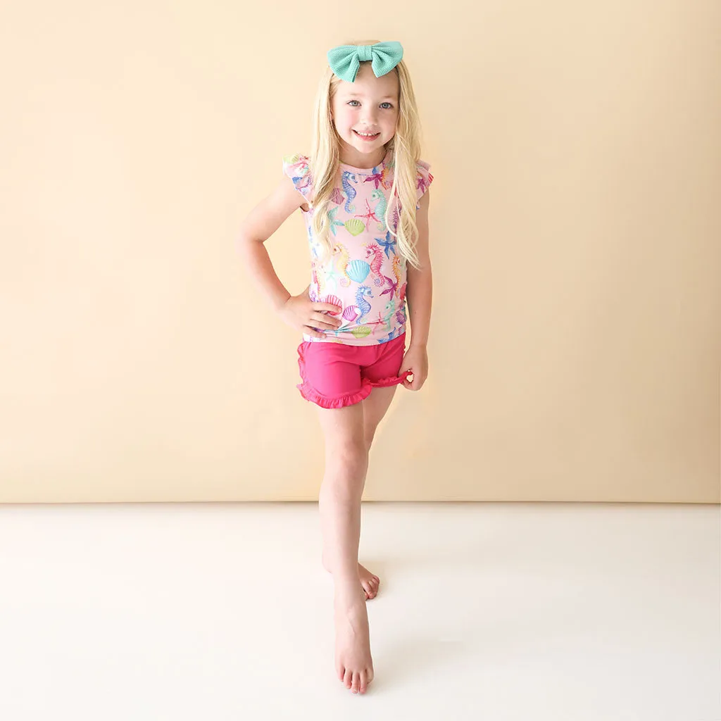 Posh Peanut Coral Basic Ruffled Capsleeve Top & Ruffled Varsity Short